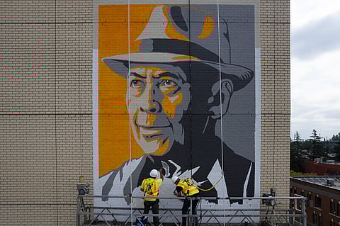 Installation view of John Santo's portrait of Uncle Bob Santos, painted by Tom Blayney with support from his painting partner, John Lihs. (Photo: Rick Wong, 2022)