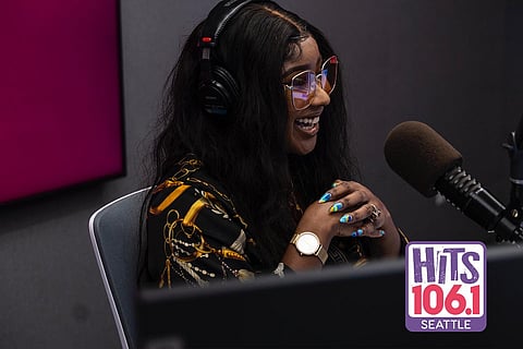 Besa Gordon in the recording booth hosting her show at iHeartRadio's HITS 106.1 (Photo courtesy of iHeartRadio Seattle.)