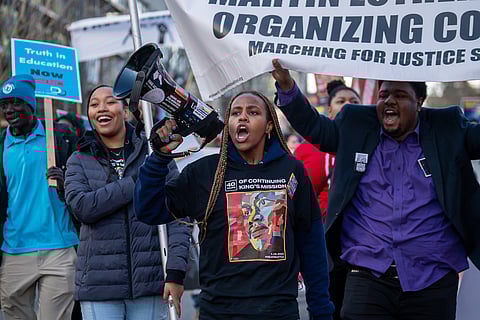 From left to right: Keimani Leonard, Alexis Mburu, and Josias Jean-Pierre lead the march from Garfield High School to Jimi Hendrix Park, Monday, Jan. 16, the 40th anniversary of Seattle's celebration of the life and legacy of the Rev. Martin Luther King Jr. (Photo: Susan Fried)