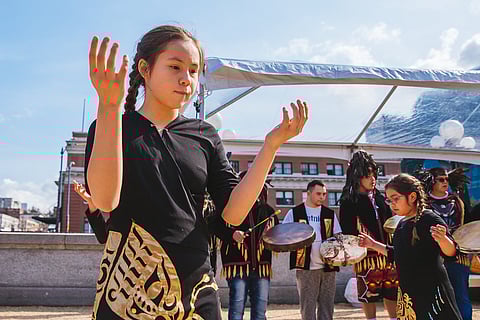 yəhaw̓'s 2019 King Street Station exhibition opening activities by Sunny Martini, featuring the Lummi Black Hawk Singers. (Photo courtesy of yəhaw̓.)