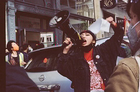 Activist Francesca Juico from Gabriela Seattle, a National Democratic organization of the Philippines advancing the militant women's movement, shouts a chant from 1986's People Power Revolution: "Makibaka! Huwag matakot!" (Fight! Do not be afraid!). Pictured at the Anakbayan U.S.A. Fourth National Congress and the BAYAN U.S.A. Seventh National Congress last month. (Photo courtesy of Anakbayan South Seattle.)