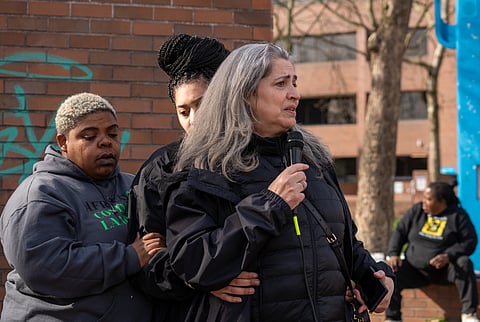 Supported by a family member and friend, Elijah Lewis' mother says a few words at a vigil held for her son at the corner of Broadway and Pine on Sunday, April 2, not far from where he was killed the day before. Hundreds of people showed up to show their love for Elijah, a young man who was deeply involved in the community. (Photo: Susan Fried)