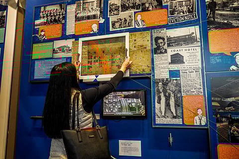 "Nobody Lives Here" includes interactive maps for guests to view the CID before and after I-5 was built. Strings extend from the map and connect to the testimonies of residents, drawn by Hulls, so guests can see what homes and businesses were displaced by the freeway construction. (Photo courtesy of the Wing Luke Museum.)
