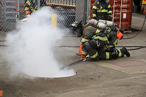 A firefighter puts on a demonstration during the Seattle City Light and Seattle Fire Department Vault Fire Response partnership event in June 2018. (Photo: K. Kennedy, courtesy of Seattle City Light.)