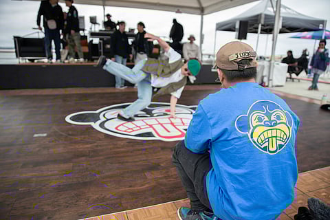 J Luck, a b-boy sporting a Massive Monkees shirt, watches as performers warm up before the competition. (Photo: Alex Garland)