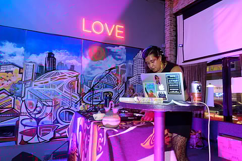 Howie Echo-Hawk DJs at an Indigiqueer dance party. (Photo: Vee Chattie)