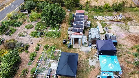 A photo captured by a drone during last year's Solar Punk Festival shows the solar panels atop the storage container. Next to the container is the greenhouse that contains the FarmBot. (Photo: Key Tech Labs)