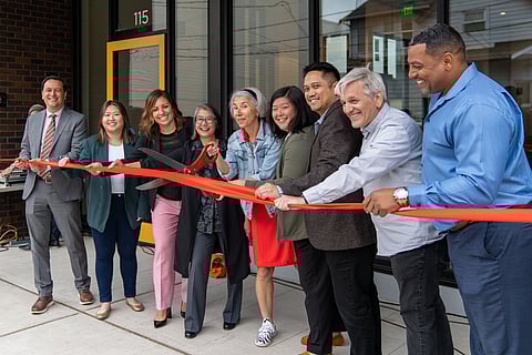 Attendees at the official ribbon-cutting at the opening of 13th & Fir: (from left to right) Deputy Mayor Greg Wong; Xiu Wen Li, Denise Louie Education Center; Councilmember Teresa Mosqueda; Susan Yang, executive director of the Denise Louie Education Center; Maiko Winkler-Chin, Director of the Office of Housing; Jamie Lee, co-executive director of SCIDpda; Jared Jonson, co-executive director of SCIDpda; Chris Persons, executive director of Community Roots Housing; and Commissioner Gerald Smiley of the Seattle Housing Authority. (Photo: Ronn CM, courtesy of SCIDpda and Community Roots Housing.)