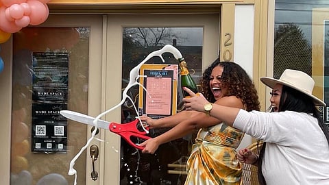 Made Space (previously The Liink Project) reopened under their new name earlier this year and is set to host a block party this weekend with neighbor Loving Room. Pictured: Stephanie Morales (with scissors) and Jody Thongoulay of Bourgeois Lashes at the reopening party. (Photo courtesy of Stephanie Morales.)