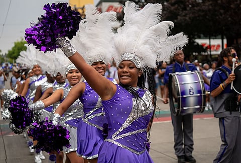 The Dolls & Gents Drill Team and Drumline entertain the crowd along 23rd Avenue during the annual Africatown Heritage Parade on Saturday, Aug. 5. (Photo: Susan Fried)