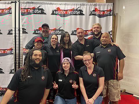 Carla Perez (in the middle of the back row) poses with the Unlock The Con staff after a signing event she did for the grand opening of the store's new location. Ashley Weaver is to the left of Perez, and Barry Weaver on the right. Picture taken in 2023. (Photo courtesy of Barry Weaver)