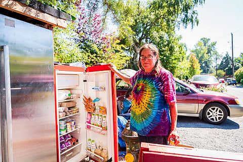 Juli Cummings opens one of the community fridges to show the stored food. (Photo: Ronnie Estoque)