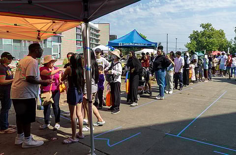 Parents and children wait in line at the Rainier Beach Action Coalition's Back2School Bash backpack and school supply giveaway. About 1,500 backpacks were distributed Saturday at the Rainier Beach Community Center. (Photo: Susan Fried)