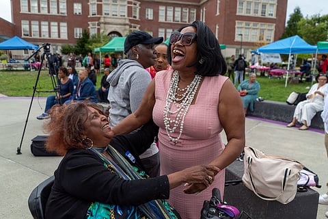 Karen Jones greets her old friend Josephine Howell at the annual ROOTS Family Celebration. (Photo: Susan Fried)
