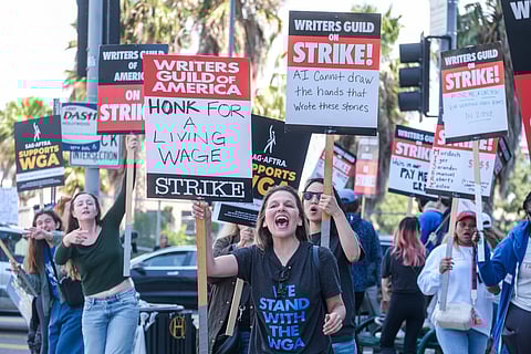 Members of the Writers Guild of America (WGA) picket outside the Netflix, Inc., building on Sunset Boulevard in Los Angeles, California, on May 5, 2023. Photo via Ringo Chiu/Shutterstock.com.