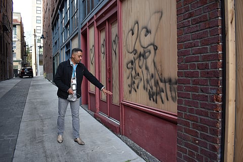 Steve McLean, communications director at the Wing Luke Museum, points to the windows, frame, and doorway of historic windows damaged at the Wing Luke Museum. A man with a sledgehammer destroyed what were living room windows in apartments that housed Chinese families in the 1920s. (Photo: Phil Manzano)