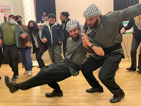 Members of Jafra Dabke Seattle demonstrating dabke, a popular folk dance performed in Palestine and other Middle Eastern countries. (Photo: Julie-C)