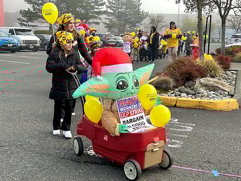 Macy's workers, family, and supporters rally in protest for better wages and safe working conditions in front of Macy's at the Westfield Southcenter mall on Black Friday, Nov. 24. The store and workers are set to meet for bargaining talks on Dec. 18. (Photo: Sharon Maeda)