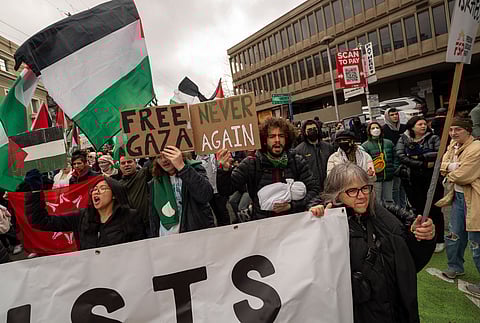 Pro-Palestinian protestors demanding an end to the siege in Gaza and an immediate ceasefire, march from the Starbucks Reserve Roastery on Pike Street to the Olive Way overpass to stand in solidarity with the people occupying the northbound lanes of I-5 on Saturday, Jan. 6. The protestors declared "No Business As Usual Under Genocide." (Photo: Susan Fried)