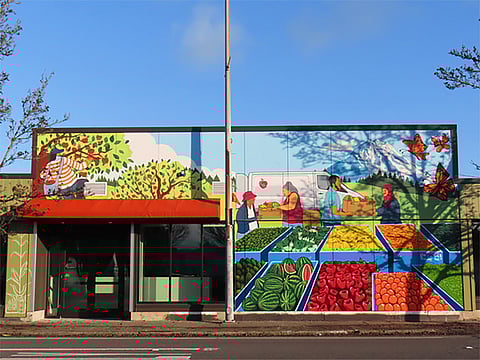 The new location of the White Center Food Bank features murals done by local neighborhood artists Jake Prendez, Rafa Diaz, and Jose Rodriguez III. (Photo courtesy of White Center Food Bank)