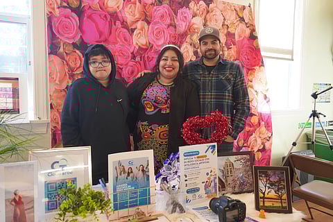 CloudTree owner Noemi Gonzaga poses for a photo with her family, who helps her with her business, behind their table at the market on Jan. 20. Her husband sometimes goes with her for support when she photographs big events, such as weddings and quinceaeras. (Photo: Julia Park)