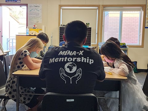 MENA-X mentor and engineering curriculum designer Kevin Chen working with students at Maple Elementary School in South Seattle. (Photo courtesy of MENA-X.)