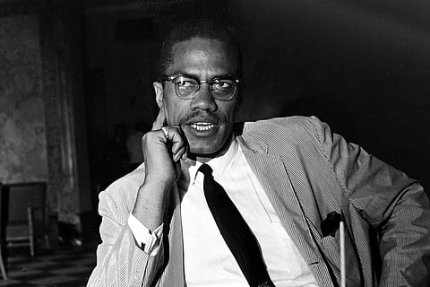 FILE — Malcolm X speaks at a news conference in the Hotel Theresa, in New York, May 21,1964. Two of the three men convicted in the assassination of Malcolm X are set to be cleared Thursday after insisting on their innocence since the 1965 killing of one of the United States' most formidable fighters for civil rights, Manhattan's top prosecutor said Wednesday, Nov. 17, 2021.  Prosecutors now say authorities withheld evidence that favored the defense in the trial of Muhammad Aziz, now 83, and the late Khalil Islam.  (AP Photo, File)
