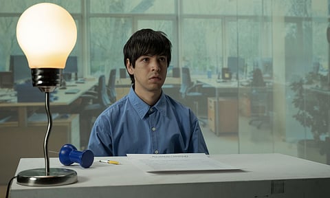 Julio Torres as Alejandro, an immigrant from El Salvador with dreams of working for the Hasbro toy company, in "Problemista." (Photo courtesy of A24.)