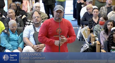 Before packed City Council chambers, Dominique Davis, founder and CEO of Community Passageways, testifies in opposition of an amendment affecting Seattle's Equitable Development Initiative. (Screenshot from City Council meeting on Seattle Channel)