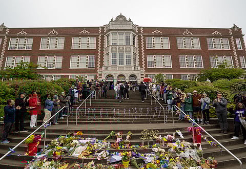 Parents and community members line the steps of Garfield High School's main entrance, Tuesday, June 11, to welcome students back less than a week after a student trying to break up a fight was shot and killed. (Photo: Susan Fried)