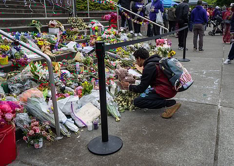 A Garfield High student leaves an offering at a memorial for Amarr Murphy-Paine. (Photo: Susan Fried)