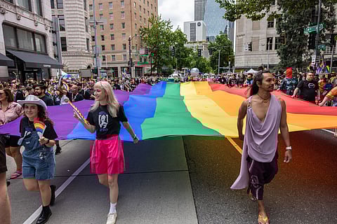 Seattle Pride Parade marchers carry a giant rainbow flag on June 30, 2024. (Photo: Alex Garland)
