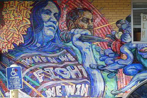 Photo by Randy Rowland, who writes: "I took this photo of a mural in Minneapolis, near the George Floyd memorial. I was initially dismayed to notice I had gotten a street sign in the photo. Then I realized how profound that made this picture. The Civil Rights Act of 1964 opened the door, and finally, after much additional struggle, in 1990 we got the Americans with Disabilities Act (ADA). … It's easy to forget our victories, and take for granted the good things we've won, but we do so at our own peril, because the right-wing is always trying to take our hard-won victories back. 'When we fight we win' indeed."