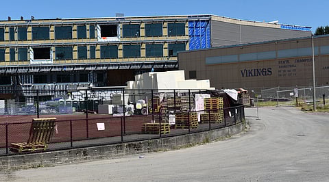 Vestiges of the old Rainier Beach High School are seen with its storied list of state championships as the construction a new high school rise behind it.(Photo: Phil Manzano)