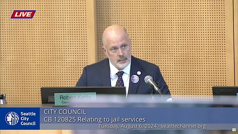 Seattle Public Safety Chair Councilmember Robert Kettle led the conversation around SCORE at the City Council Meeting on Tuesday, Aug. 6, 2024. Many individuals present for public comment held protest signs opposing SCORE. Screenshot from a Seattle Channel broadcast of a Seattle City Council meeting on Aug. 6, 2024.