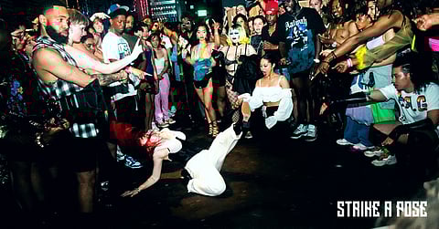 An enthusiastic crowd cheers on performer Bird Ada(on the floor). (Photo courtesy of Strike A Pose.)