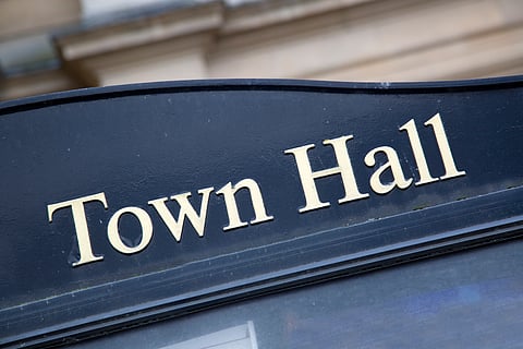 Town hall in gold lettering on a black sign