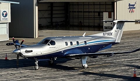 An airplane in front of a hanger