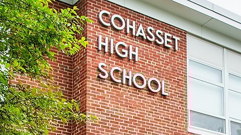 A brick school building with Cohasset High School in raised letters.