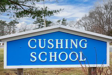 A blue sign for Cushing School