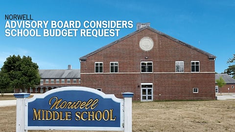 Exterior shot of the red brick Norwell Middle School building with the blue and white sign that says Norwell Middle School in front of it.