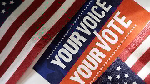 American flag with the words your voice your vote over it