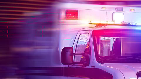 Up close image of a white ambulance with the lights creating a glowy effect