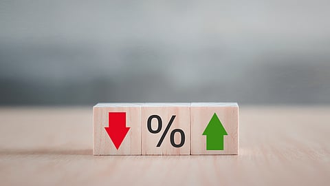 wooden blocks showing a red down arrow and a green up arrow with a block with a percent sign in the middle