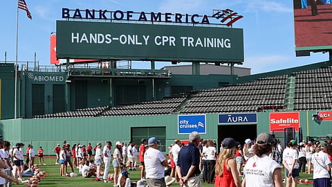 Fenway park with CPR dummies and volunteers learning hands only CPR