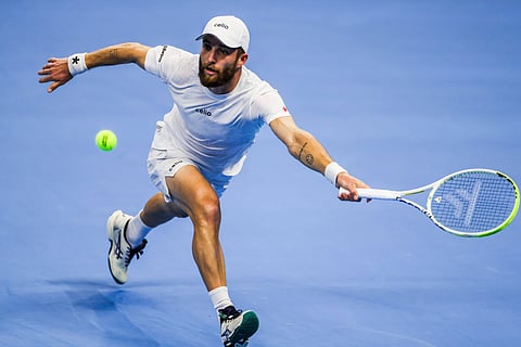 Corentin Moutet returns a shot