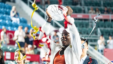 Victoria Mboko celebrates after winning a title