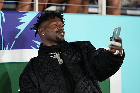 Former NFL player Antonio Brown takes a selfie in 2022 with a fan