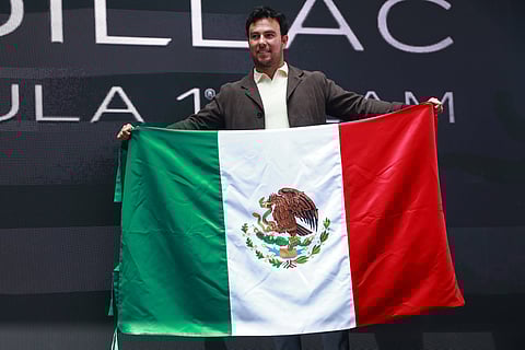 Sergio Perez waves the Mexican flag