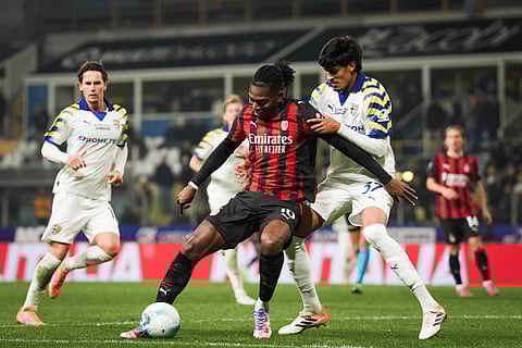 Rafael Leao tries to keep possession of the ball
